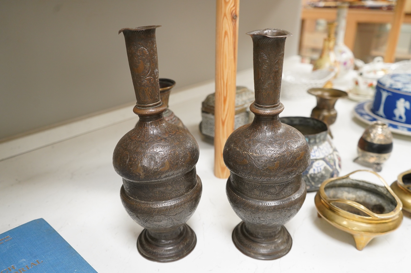 A collection of Persian, Eastern and Chinese metalware to include two brass tripod censers, pair of vases and an enamel bowl, largest 33cm high
